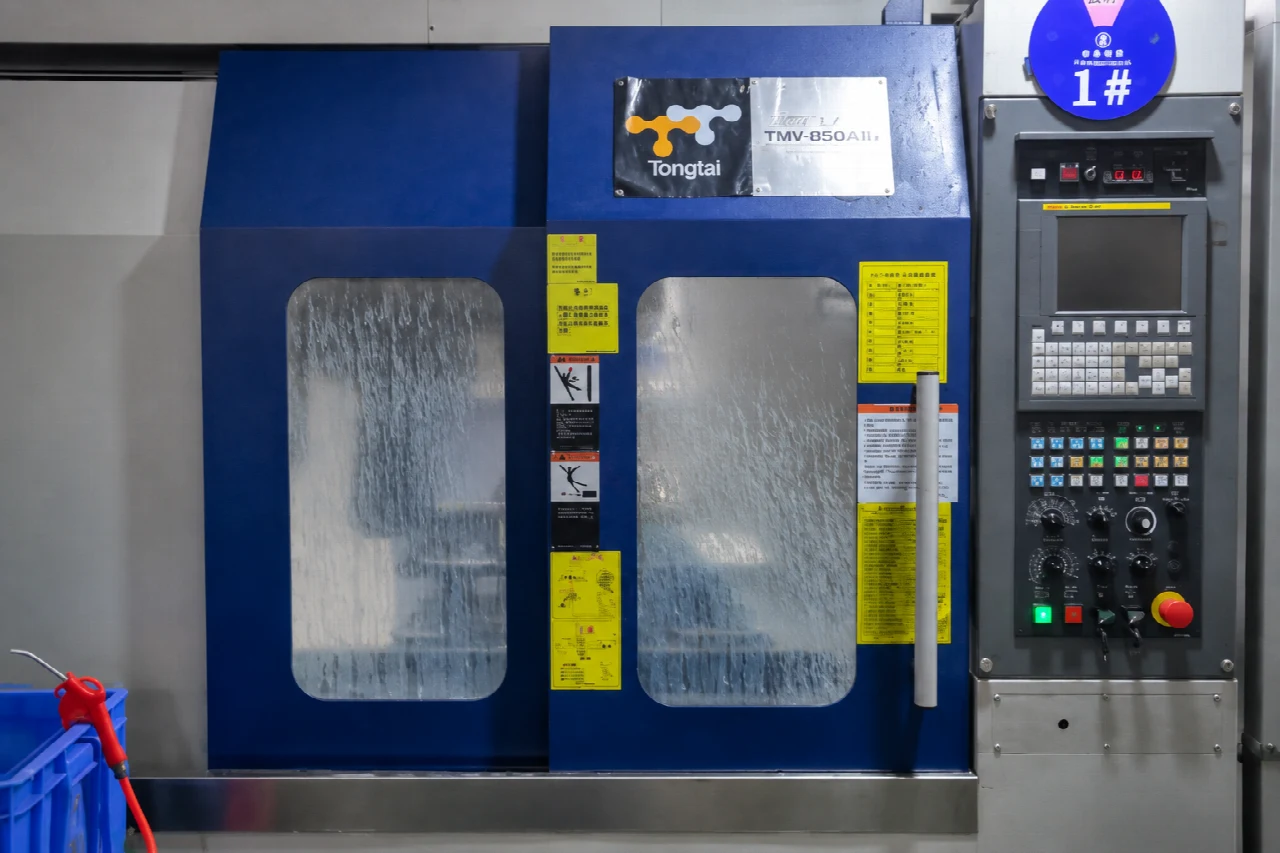 CNC machining center with blue doors and a control panel