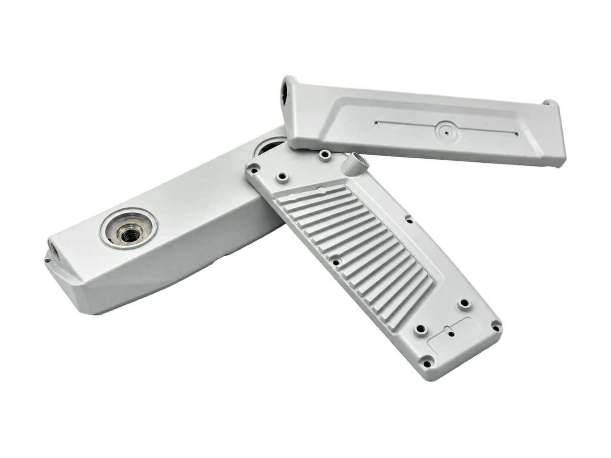 Metal lighting housing components showing a finned body, cover and mounting interfaces